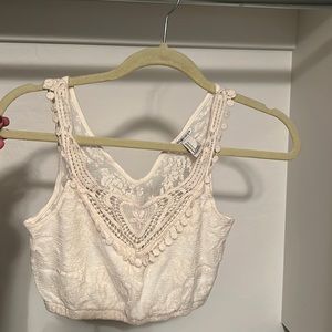 Forever 21 cropped off white lace shirt and is see through in the back.